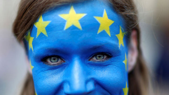 Women with painted EU flag on her face