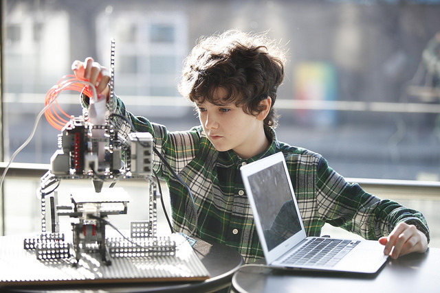 Boy with computer and robot